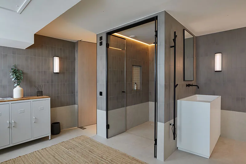 Shower room with tiled walls, walk-in glazed shower and freestanding basin