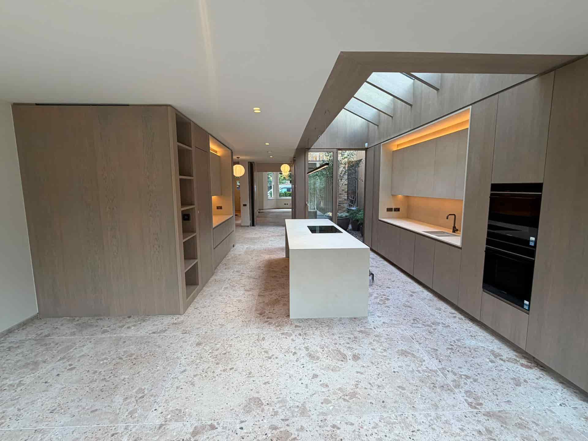 Luxury London home interior with herringbone floor and sculptural staircase